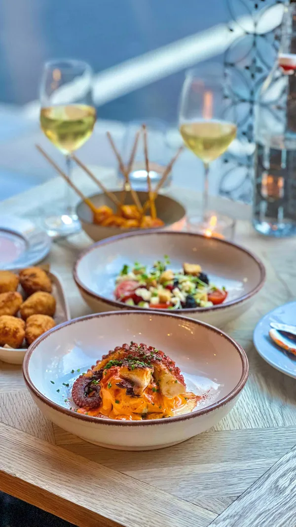 The video showcases a meal at Iberica restaurant. It features various tapas dishes, including a slow-cooked egg dish, croquettes, roasted chicken, and churros. The food is presented beautifully, with a focus on close-up shots highlighting textures and colors. The setting is a modern, well-lit restaurant.