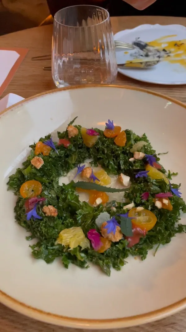 The video showcases a meal at Arros QD restaurant in celebration of World Paella Day.  Various dishes are presented, including different types of paella, a kale salad, bread, and desserts. The presentation focuses on the visual appeal of the food, with close-up shots and overhead shots. No specific dietary information is provided.