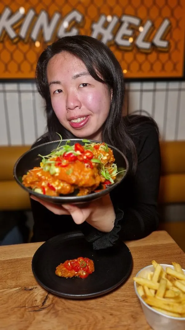 The video showcases various chicken wing dishes from Wingmans Chicken restaurant. It features close-up shots of different wing flavors (e.g., buffalo, Jamaican hot wings), alongside fries and dipping sauces. The presentation highlights the vibrant colors and textures of the food, emphasizing deliciousness. The primary focus is a meal showcase with multiple angles to highlight the food.