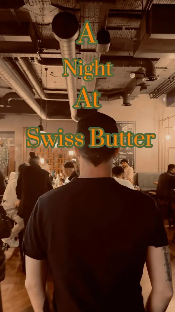 The video showcases a night at Swiss Butter restaurant in London.  It features various dishes, including steak with a creamy sauce, fries, salad, bread, and salmon with a similar sauce and sides. The presentation involves individual servings on wooden boards with small side dishes.  The video focuses on the food and the ambiance of the restaurant.