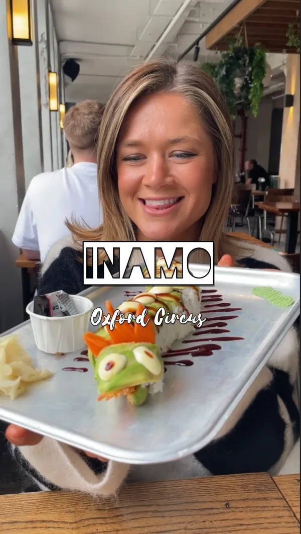 This video showcases a meal at Inamo Sukoshi in Market Halls, Oxford Street. The food includes duck-topped fries, a karaage chicken burger, a dragon sushi roll, and duck ramen.  The presentation is visually appealing, focusing on vibrant colors and creative plating. The video highlights the positive experience of the food and the restaurant. No dietary information is provided explicitly.