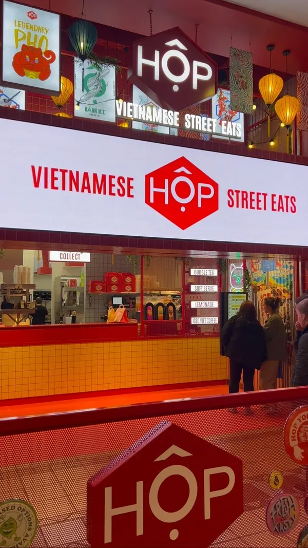 The video showcases Hop Vietnamese Street Eats in the Manchester Trafford Centre. It highlights various dishes, including Banh Mi baguettes, noodle salads, rice boxes, and drinks like bubble tea and Vietnamese coffee.  The food is presented in appealing, well-lit shots, showcasing textures and colors.  Vegan and vegetarian options are explicitly mentioned. The primary focus is on showcasing the food and the restaurant's atmosphere.