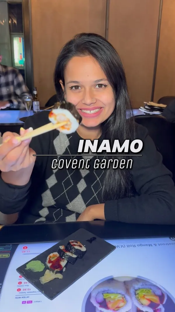 The video showcases Inamo restaurant in Covent Garden, London. It highlights the restaurant's interactive tabletop ordering system and various Pan-Asian dishes, including bao buns, sushi, sashimi, fried rice, and noodles.  The video emphasizes the dining experience and the games available on the tabletops. Dietary information is partially present, indicating some vegetarian options (V,Ve). The primary focus is showcasing the restaurant's unique concept and food offerings.
