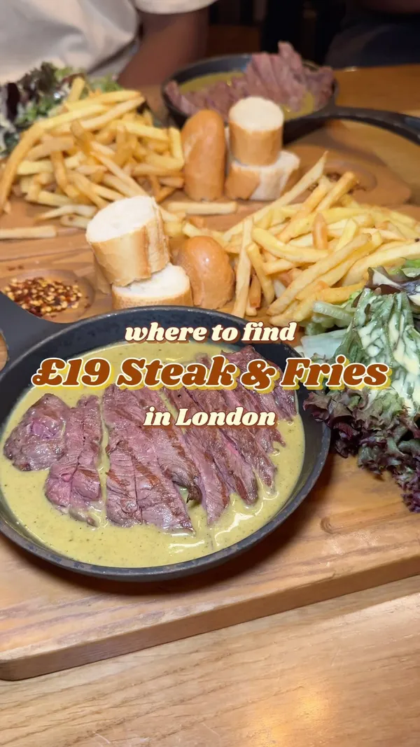 The video showcases Swiss Butter restaurant in London. It features various food items, including steak (ribeye and fillet) and a double patty burger, all served with fries, salad, and baguette.  The food is generously doused in a signature Swiss butter sauce. The video also includes scenes of individuals enjoying cocktails (Mai Tais). The presentation emphasizes large portions and an appetizing display of food.