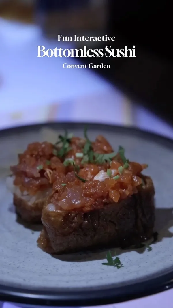 The video showcases inamo restaurant, focusing on its interactive, bottomless sushi experience.  Various sushi dishes and tapas are presented, highlighting their visual appeal. The interactive table features games, adding to the dining experience.  No specific dietary information is provided.