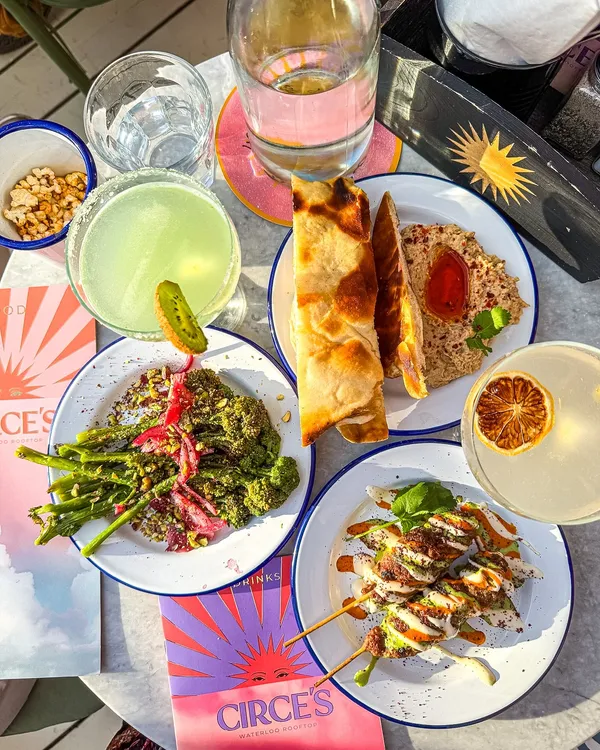 Sunshine☀️ food at @circes_rooftop 

The sun might be playing hide and seek⛅️, but Circe’s new Summer menu is bringing the heat! ☀️🍴

We got a first taste of their Mediterranean-inspired🌅 spread—think fresh, vibrant plates made to be shared, paired with refreshing cocktails that taste like vacation in a glass. 🌿🍸 Fresh, seasonal ingredients. Skyline views. Easygoing vibes. Circe’s is THE spot for golden hour grazing with your favourite people. 💛

🍽️Small plates 
🍡Spiced Lamb Kofta Skewers | With a garlic, chilli, and coriander dressing 🦐Tiger Prawns | Chilli, garlic, parsley, extra virgin olive oil on toasted focaccia
🥦Grilled Broccoli | Purple sprouting broccoli, crushed pistachio, sumac and red onion 🍆Baba Ganoush | Chilli oil, coriander and flatbread 🧀Buffalo Mozzarella | Courgette ribbons and basil oil
🧀Fried Halloumi | Honey and Aleppo chilli, fennel and nigella seeds  
🍸Cocktails 🍹Peach Gimlet | Bombay Sapphire Gin, peach syrup, lime juice 🍹Kiwi Margarita | Cazadores Tequila, Cointreau, kiwi syrup & lime juice 🥃Cocoa Nero Negroni | Cazcabel Coffee Tequila, sweet vermouth, Campari, crème de cacao & caramel 🍸Pornstar Martini | Absolut Vanilla Vodka, Passoā Passionfruit Liqueur, passionfruit, vanilla, Prosecco on the side

✨ Launching from this April — get ready to sip, snack, and soak it all in.

Invite via @joli_app 

#rooftopbar #rooftoprestaurant #rooftoplondon #rooftopgarden #views #londonrooftops #londonbars #rooftop #roofgarden #terrace #gardenterrace 
#rooftopview #rooftopvibes #rooftopterrace #chasingrooftops #chasing_rooftops #londonbar  #londoncity #londoncityworld #rooftopbarlondon #rooftopbars #londonviews #londonview #londonviewpoints #londonskyline #londonskybar