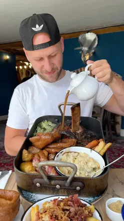 Gigantic Sunday roast in Kent with yorkshire puddings, roast potatoes, pigs in blankets, and choice of chicken, lamb, beef, or pork.
