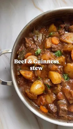 Beef and Guinness stew with carrots, celery, onions, potatoes, and herbs, baked for 3 hours; cozy comfort food.
