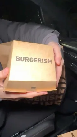 Juicy free bird burger from Burgerism in Manchester, known for the best burgers, with crispy chicken and savory toppings.