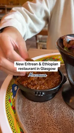 Massawa restaurant in Glasgow offers Eritrean and Ethiopian platters with injera, stews, vegan options, and a cozy group setting.