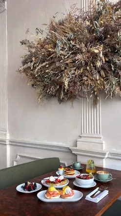 WOLFOX Savoy cafe in London, featuring artisan coffee, brunch dishes like Greek yogurt with granola, and smashed avocado toast.