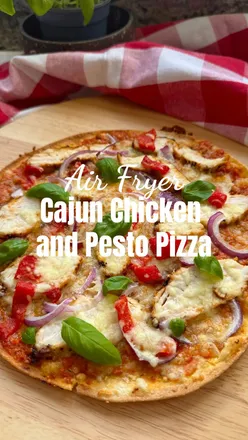 Air Fryer Cajun Chicken & Pesto Pizza 🍕

I love this lighter style pizza flatbread for summer, and my homemade red pesto flavours work so well as the base. 

Crispy, smoky, spicy and ready in minutes, perfect for summer nights.

Ingredients: serves 1

Skinny Italian Pizza Base from @fitzgeraldsbakery.ie 
Or a tortilla or flatbread  2 tbsp red pepper pesto (my homemade one) 1 small chicken breast, sliced
1 tsp Cajun seasoning  1/4 Red onion, thinly sliced 1 tbsp diced red pepper 50g mozzarella, grated Fresh basil leaves

Method:

For the chicken, rub the breast with a little olive oil then rub in the Cajun seasoning and air fry for 12-16 minutes (depending on the size of the breast) at 200c on the standard air fry setting.

Spray a pan with a little olive oil then add the pizza base into the pan.
 Spread the pesto right to the edges.
 Top with sliced Cajun chicken, red onion, and red pepper, I used some of the air fried pepper from my pesto recipe. Then add the cheese.
 Toast the bottom in the pan until crisp and golden.
 Finish under the grill until the cheese is melted and bubbling.

Then add some fresh basil, slice and serve!
.
.
.
#pizza #flatbreadpizza #cajunchicken #redpesto #chickenpizza #summerrecipes #pestopizza