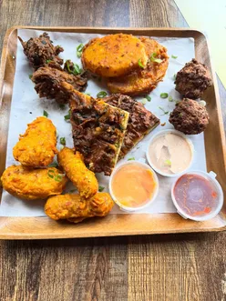 Feast at Pakora Shack: mixed platter, pakora naan, fish & chips, chickora burger, pakora chips; flavorful, crispy, non-oily.