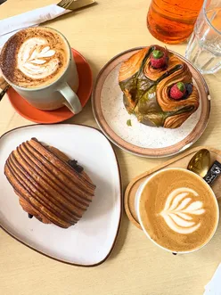 Buttery, flaky pain au chocolat with rich chocolate in Glasgow's Southside cafe, alongside matcha custard and raspberry jam swirl.