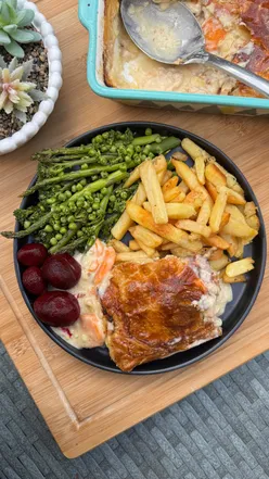 Chicken and ham pie with homemade chips, green veggies, and pickled beetroot, perfect for a cozy, rainy day meal.