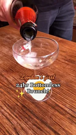 Bottomless brunch in London with champagne flutes, vibrant dishes, and lively atmosphere. Perfect summer dining experience.