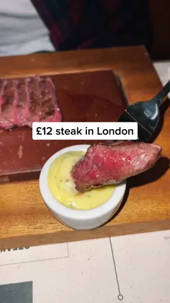 Juicy steak served at Flat Iron, London's top affordable date night spot. Perfect for foodies seeking London hotspots.