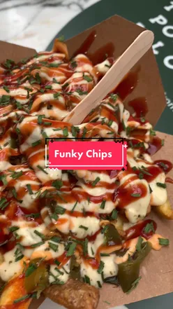 Close-up of masala fries in Camden Market, London, with vibrant spices and herbs, perfect for foodies exploring Camden.