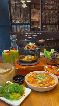 Cozy London restaurant interior with halal Korean food, featuring teokbokki, dumplings, and KBBQ.