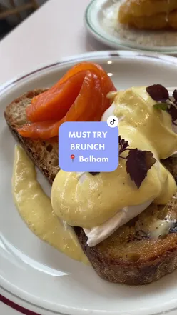 Brunch plate with young Betty eggs, brown butter hollandaise, cheesy hash browns, and banana bread at Milk Balham, London.