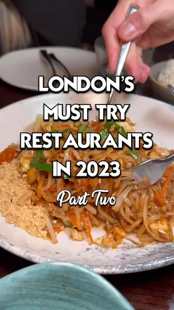 Plate of gourmet London cuisine with vibrant vegetables and herbs, highlighting top 2023 restaurant dishes.