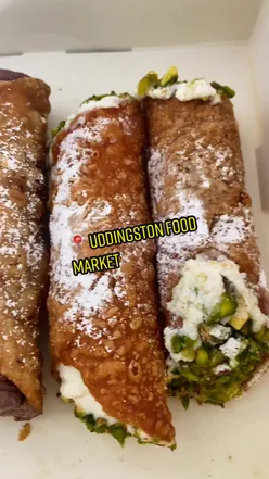 Colorful stalls at Uddingston Food Market showcasing fresh local produce and delicious Scottish treats.