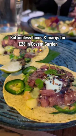 Delicious homemade pizza topped with fresh basil, mozzarella, and tomatoes on a rustic wooden table.