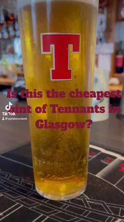 A vibrant bar scene at Horseshoe in Glasgow, featuring Tennents Lager and delicious bar eats.