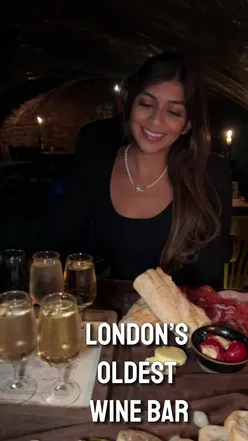 Cozy London wine bar with vintage wines, cheese platter, and fresh bread. Discover this hidden gem near Embankment.