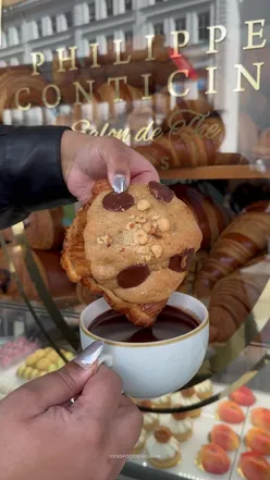 Close-up of a £5.9 cookie croissant at Philippe Conticini, London, showcasing flaky layers and rich cookie dough filling.