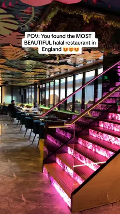 Contemporary UK restaurant with dramatic lighting, serving international menu; highlights include BBQ short ribs and Baklava dessert.