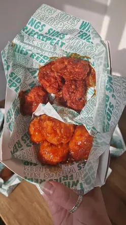 Assorted Wingstop UK chicken wings with garlic parmesan and atomic flavors on a platter. #wingstop #garlicparm