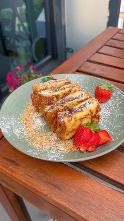 Nutella French Toast with strawberries on a plate, showcasing a budget-friendly brunch recipe with brioche and Frosties.