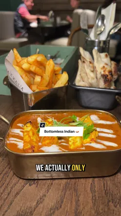 Dakwala Bombay Canteen's Bottomless Sunday Feast in Newcastle with Indian decor, featuring Vada Pav, Chicken Tikka, Butter Chicken, and Gulab Jamun.