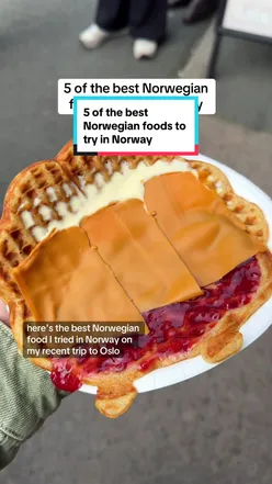 Plate of Norwegian waffles with brunost, seafood platter, pølse with lompe, meatballs, and fiskegrateng in Oslo, Norway.