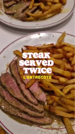 Plate of steak with creamy sauce, crispy golden fries, and walnut salad at Le Relais de Venise l'Entrecôte, Marylebone.