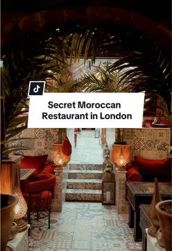 Plate of Moroccan couscous with vegetables at Oasis Lounge, London. Authentic Moroccan food in a cozy setting.