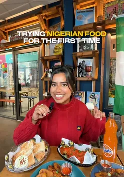 Plate of Nigerian jollof rice with plantains and chicken, first-time tasting, London food experience.