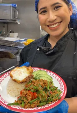 Spicy Pad Kra Prow stir fry with holy basil and chili at Rosa's Thai, capturing fiery Thai street food flavors.