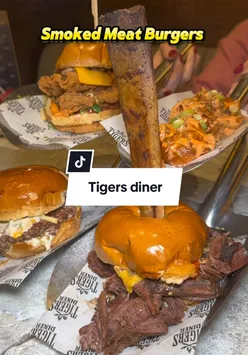 Juicy burger with fried chicken and smoked meat at Tiger's Diner UK, perfect for food lovers. #burger #food