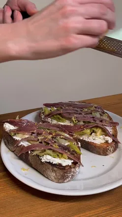 Sourdough topped with wilted British leeks, ricotta, anchovies, chili flakes, and lemon zest for a savory winter lunch.