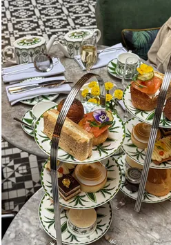 Elegant afternoon tea spread with pastries and tea at The Refuge, Kimpton Clocktower Hotel, Manchester.