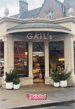 Barista pouring latte art into a coffee cup at 52 Whiteladies Road cafe, inviting weekend coffee lovers.