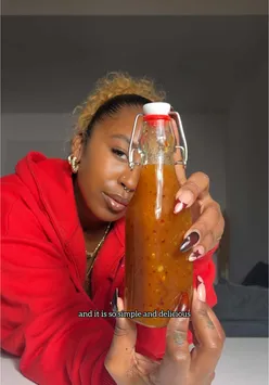 Homemade pineapple sweet chilli sauce in a jar, featuring fresh pineapple, Scotch bonnet, and lime for a sweet, spicy flavor.