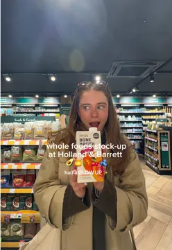 Assorted whole foods including avocados, honey, cherries, and blueberries from Holland & Barrett, promoting healthy snacks.