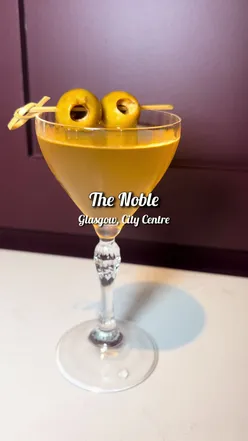 Martinis and fresh oysters on a table in a Glasgow restaurant, perfect for foodies exploring local cuisine.