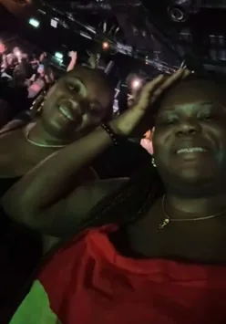 Celebrating Ghana's Independence Day with friends at a lively concert, enjoying music and culture together.