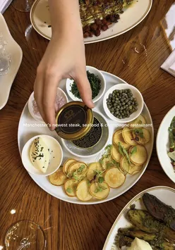 The Cut & Craft Manchester steak and seafood restaurant interior with steak and caviar dishes.