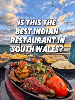 Cozy pod dining at 1988 Indian in South Wales with ocean views; enjoying spicy Chicken Chaat, Bombay Aloo, and Garlic Tikka Chicken.
