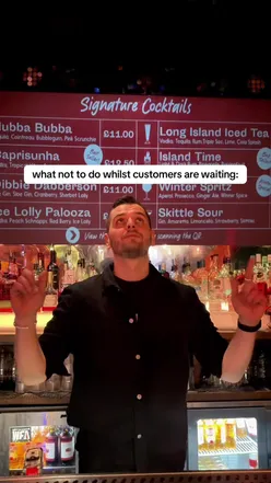 A bartender skillfully mixing cocktails in a vibrant bar, showcasing hospitality and customer service.